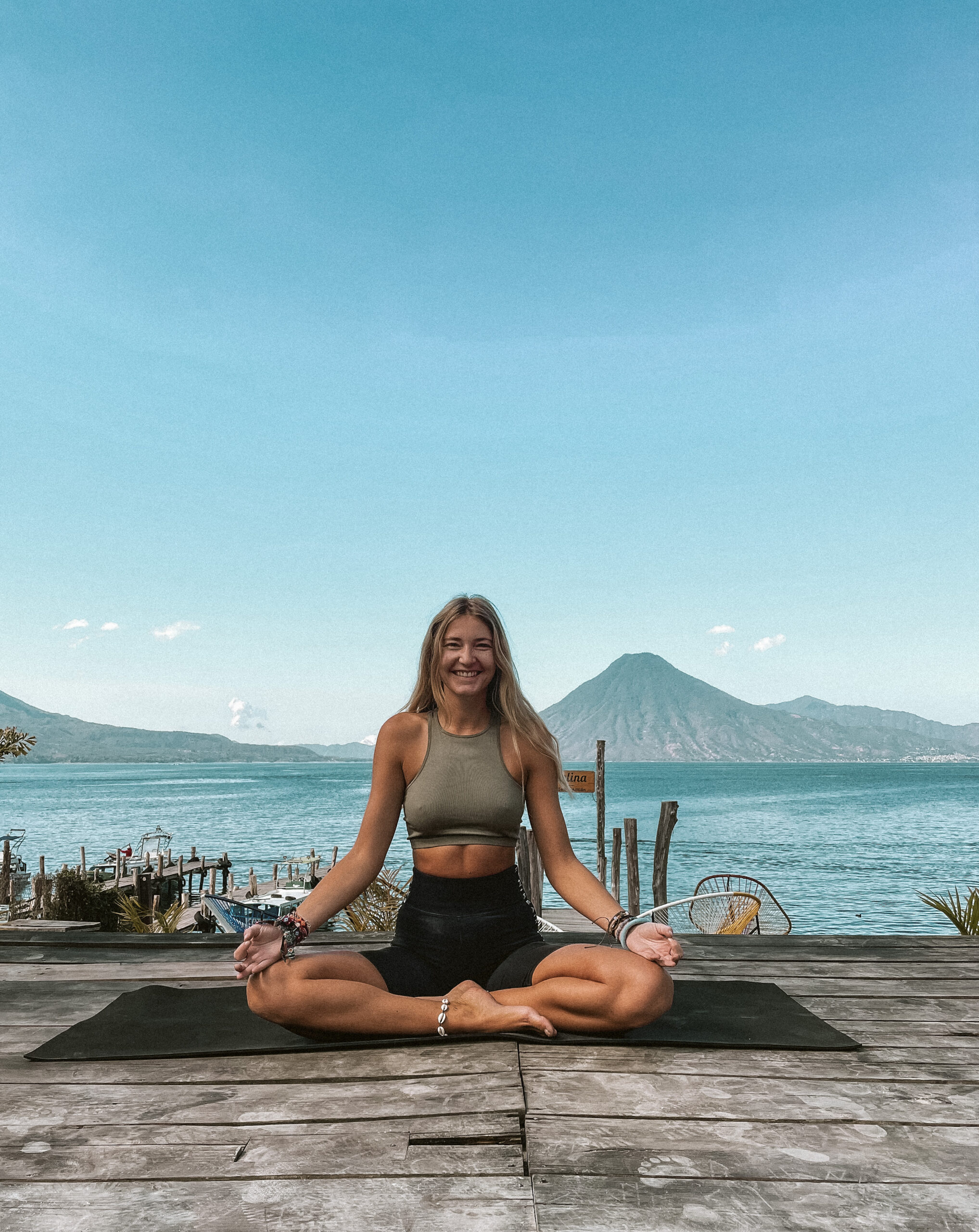 women in lotus pose at lake Atitlan Guatemala