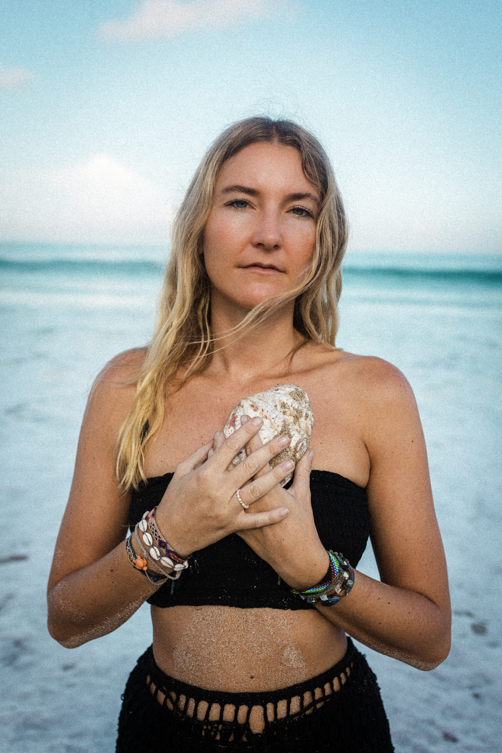 portrait of women on beach with shell in front of heart